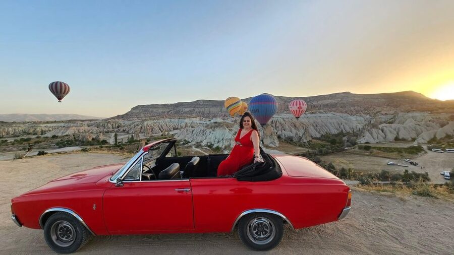 Cappadocia: Sunrise, Day Tour & Sunset Classic Car Tour - A vintage car under Cappadocia’s morning balloons