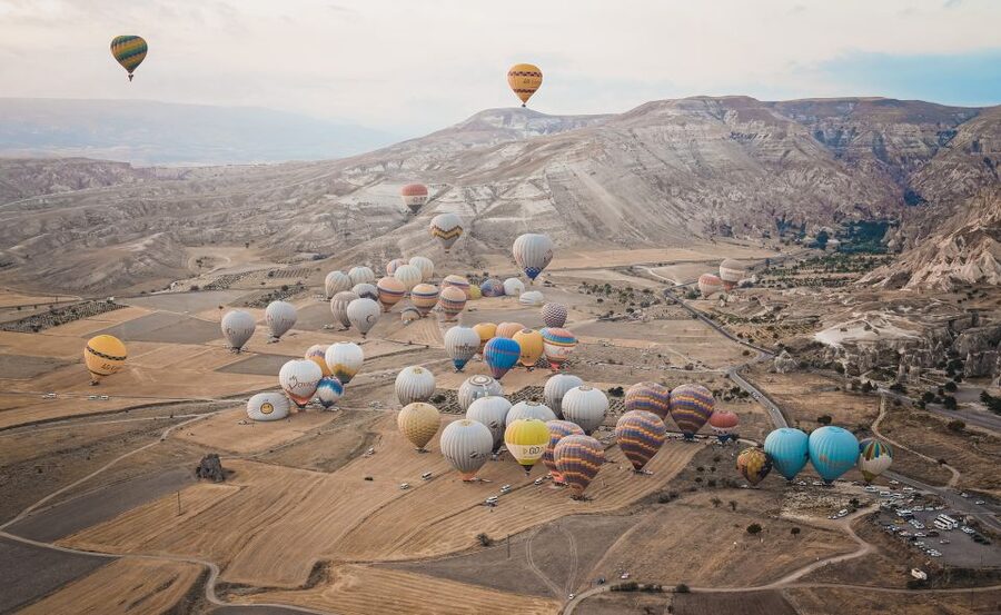 Hot air balloons in Goreme red valley - Looking Toward Pasabag and Uçhisar Castle